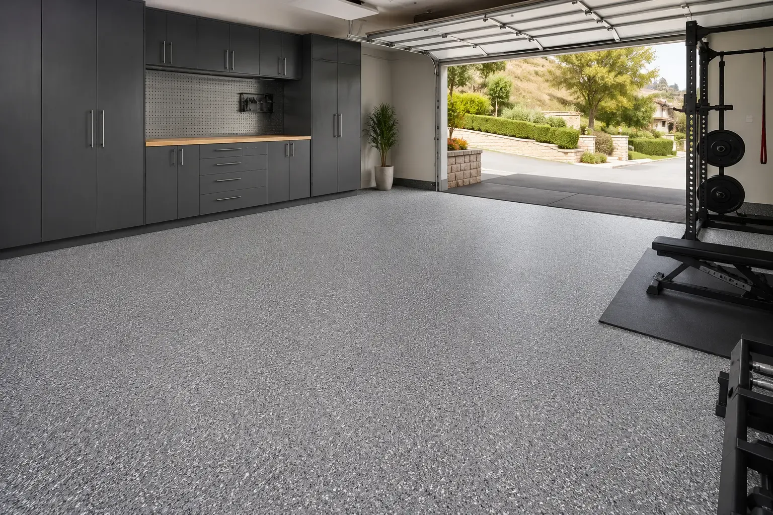 Example of a light-gray flake garage floor in a garage set up as a home gym — Chino Hills, CA service area